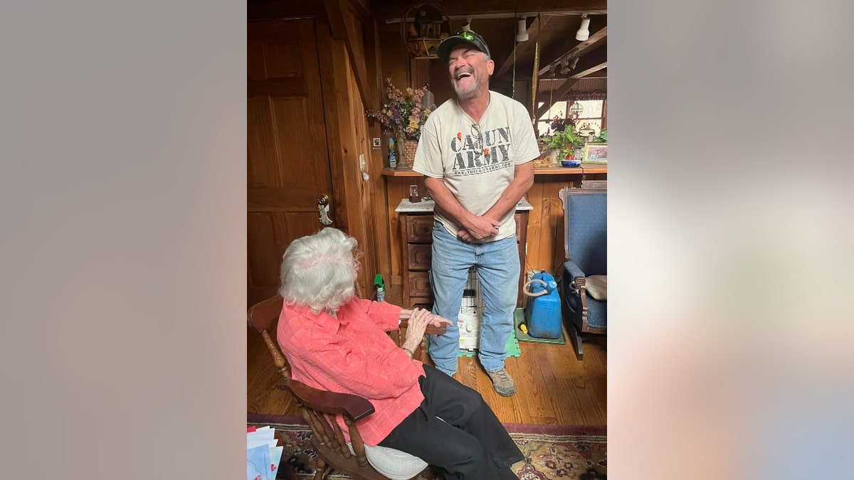 A Cajun Navy 2016 volunteer laughs with Ms. Jo Jane