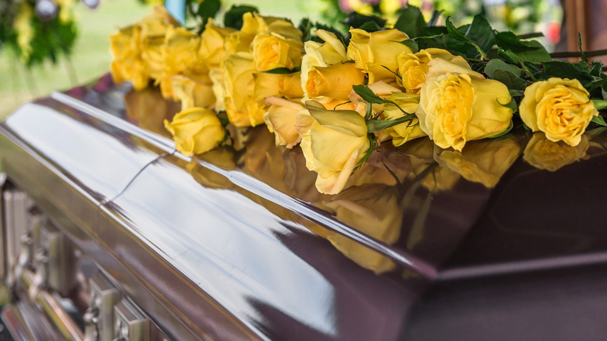 a casket with flowers on it