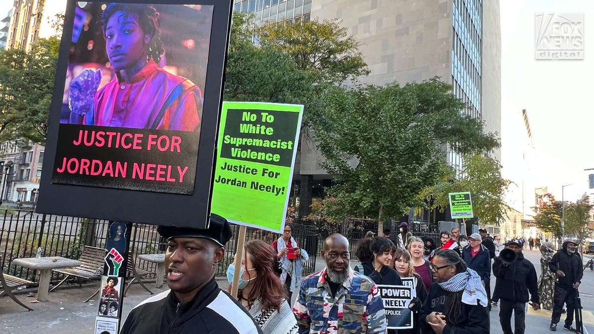 Protestors hold signs seeking justice for Jordan Neely who was allegedly choked to death by Daniel Penny on a New York City Subway last year