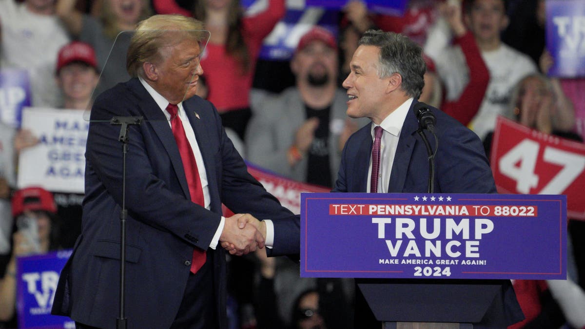 Republican presidential nominee former President Trump greets Dave McCormick, Republican nominee for U.S. Senate in Pennsylvania, during a campaign event in Reading, Pa., on Oct. 9, 2024.