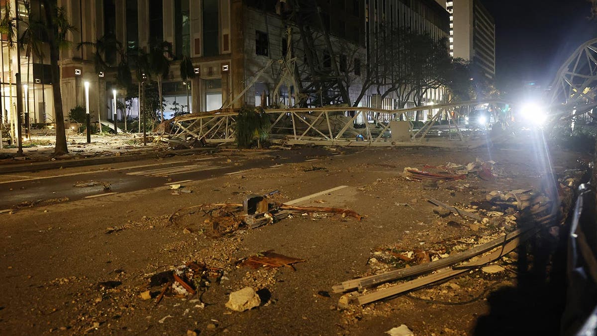 A crane sits on the street after crashing down into the building housing the Tampa Bay Times