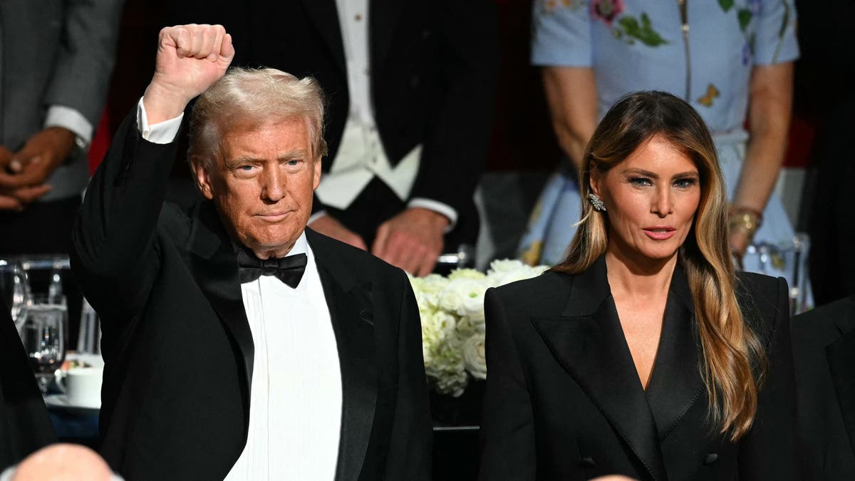 Former US President and Republican presidential candidate Donald Trump raises his fist as he and his wife Melania Trump attend the 79th Annual Alfred E. Smith Memorial Foundation Dinner at the Hilton Midtown in New York, October 17, 2024. (Photo by Timothy A. CLARY / AFP) (Photo by TIMOTHY A. CLARY/AFP via Getty Images)