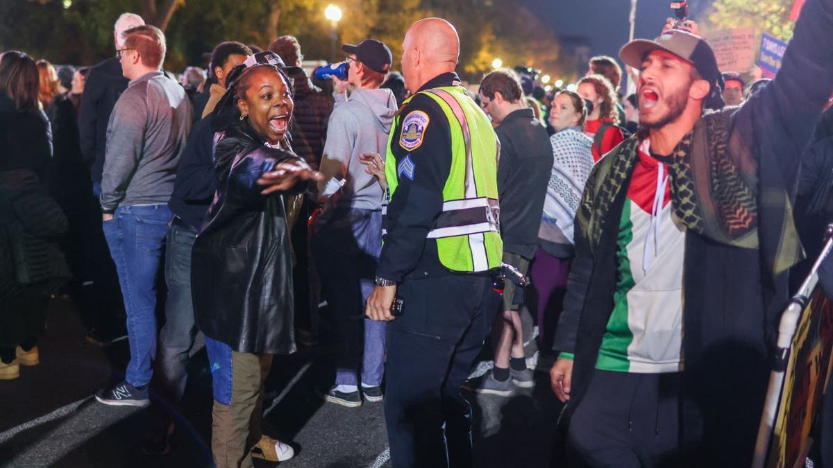 Protesters interacting with police outside Harris rally