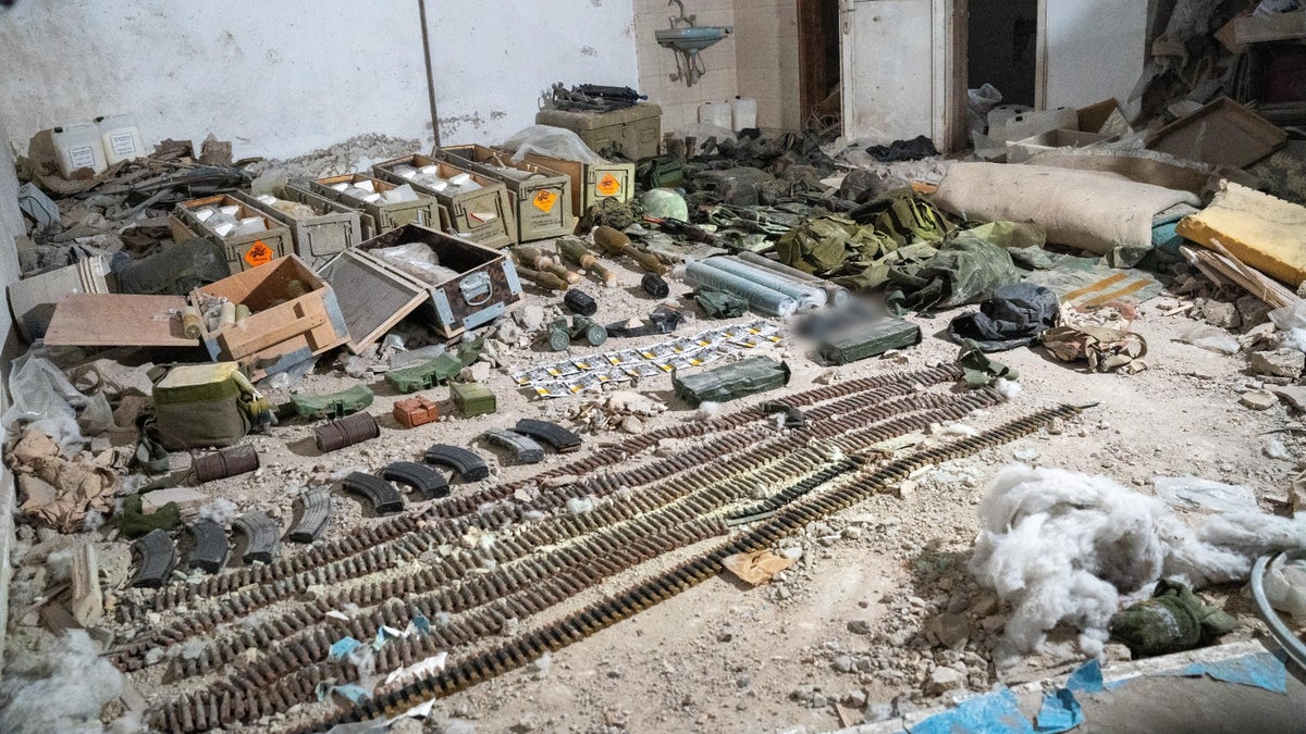 Israeli troops display Hezbollah weapons found in south Lebanon.