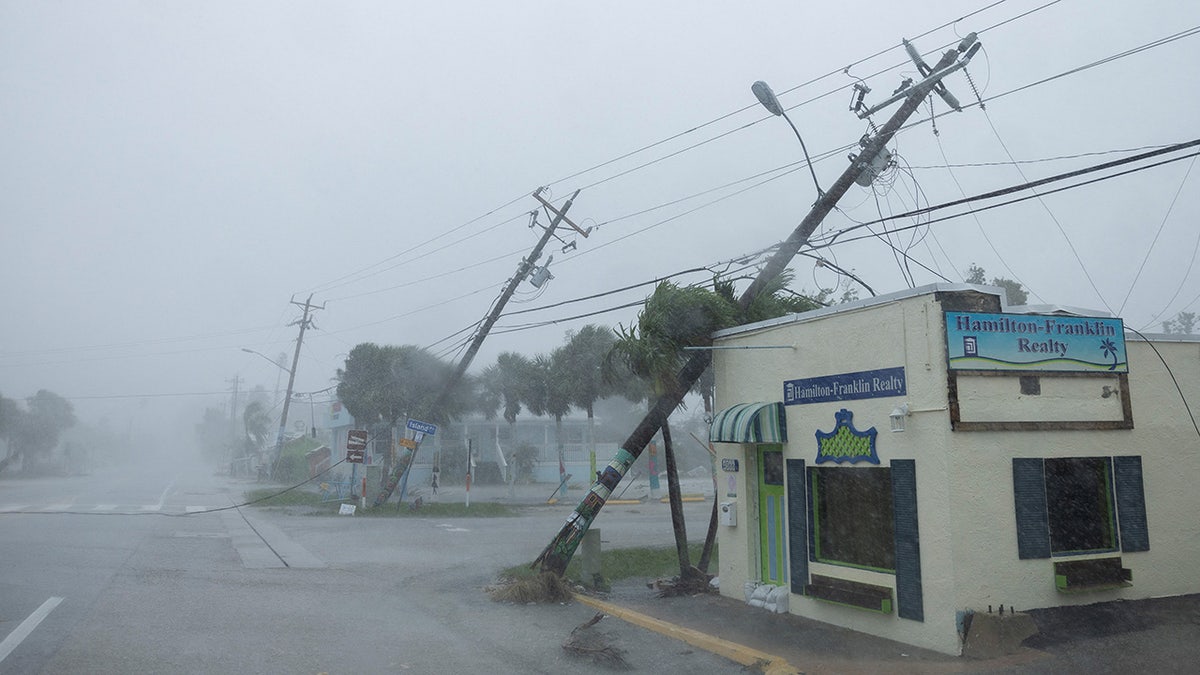 Broken utility poles downed by strong wind gusts are seen as Hurricane Milton approaches Fort Myers, Florida