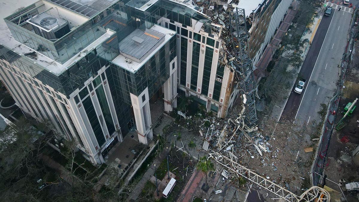 A crane smashes part of an office building in Tampa after Hurricane Milton