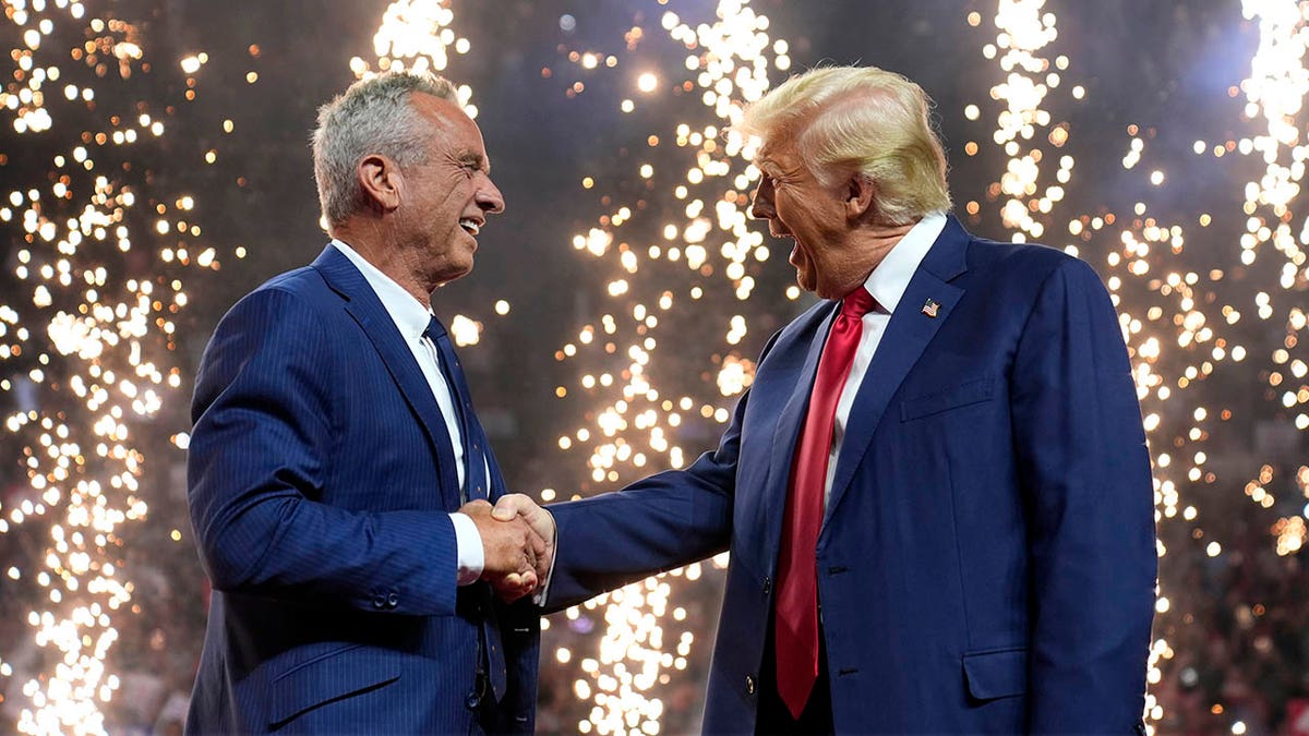 Trump and RFK Jr shaking hands with fireworks in the background