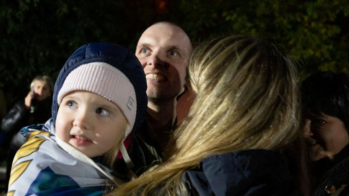 A freed Ukrainian prisoner of war is shown with his relatives after a swap at an undisclosed location in this handout picture obtained on Oct. 19, 2024. (Ukrainian Presidential Press Service/via Reuters)