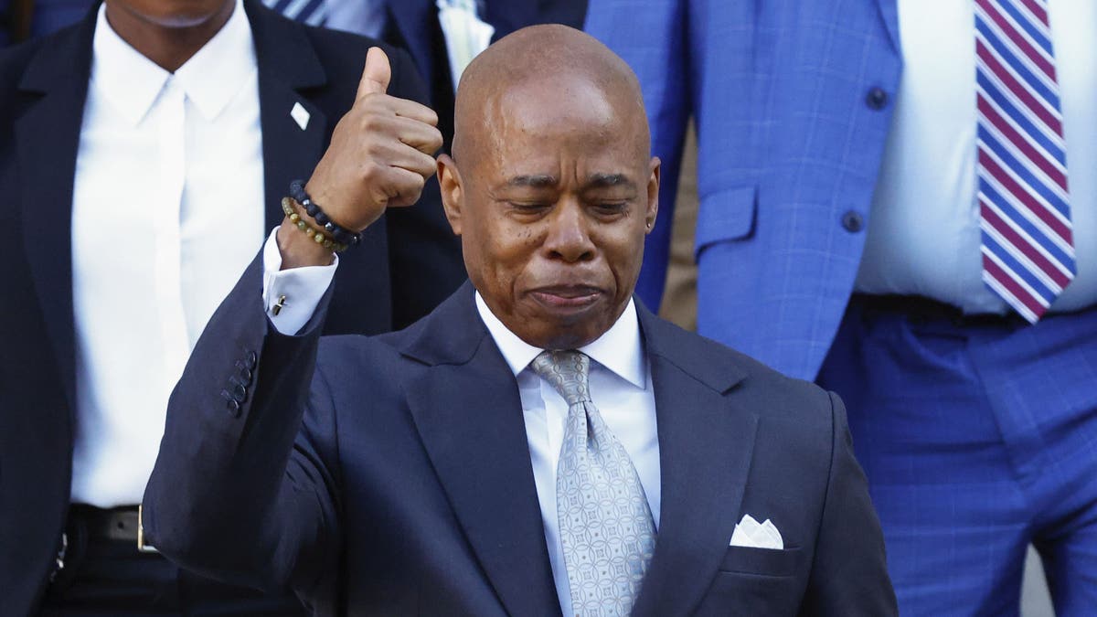 adams gives thumbs up outside courthouse