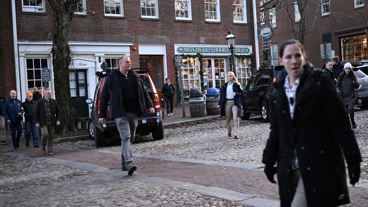 Secret Service agents walk ahead of US President Joe Biden (L) as he visits shops in the island's Downtown Historic District with relatives in Nantucket, Massachusetts, on November 25, 2023.