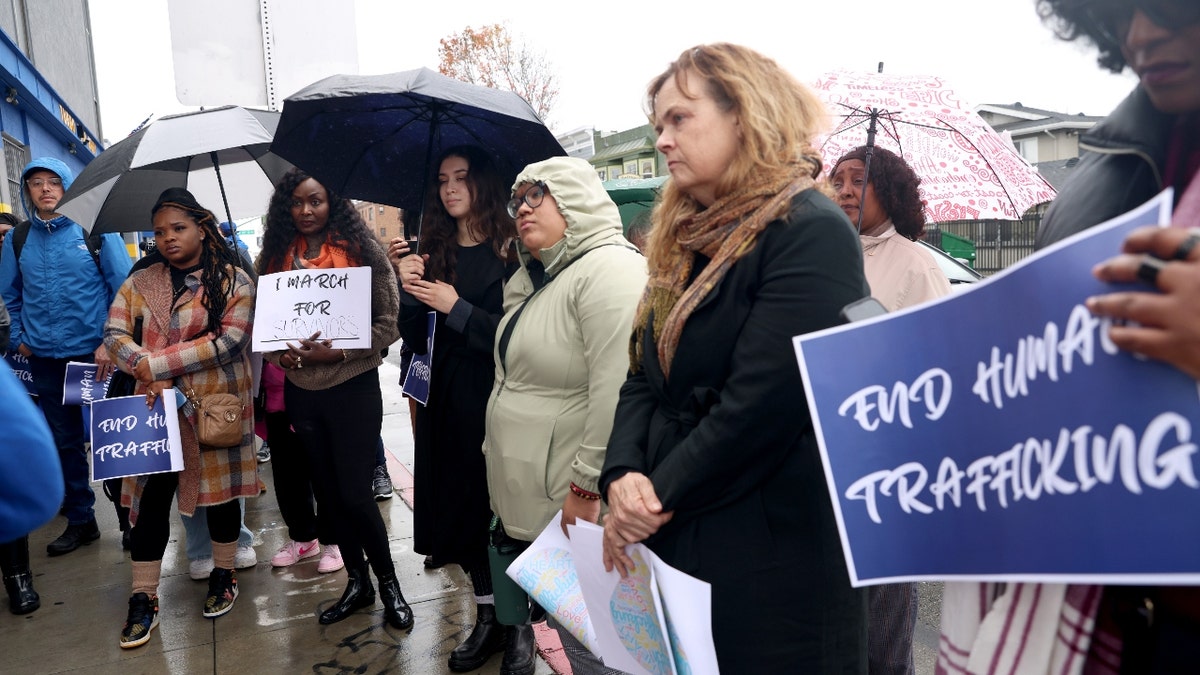 Community members listen to Alameda County District Attorney Pamela Price speak at International Boulevard and 17th Street before a march to raise awareness of human trafficking in Oakland, Calif., on Wednesday, Jan. 24, 2023.