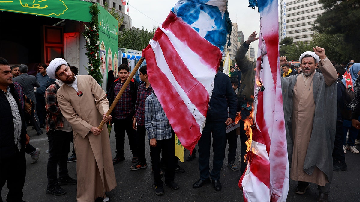 Iranian protesters burn American flag