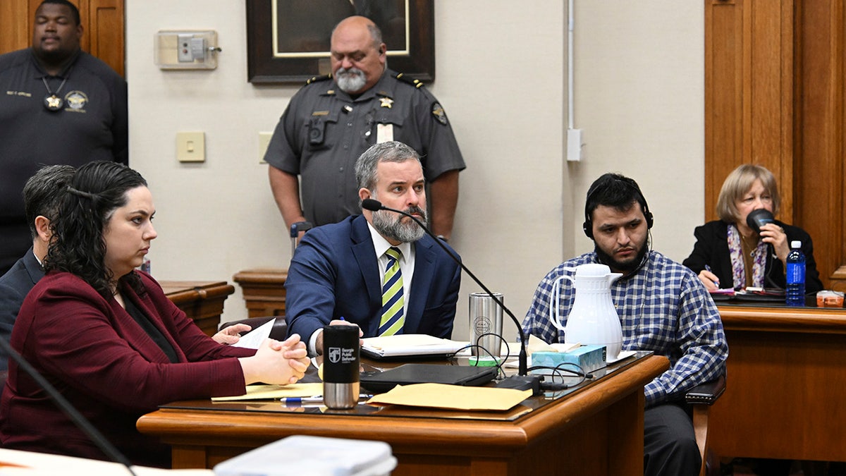 Jose Ibarra, accused of killing a Georgia nursing student earlier this year, listens through an interpreter as he sits with his attorneys