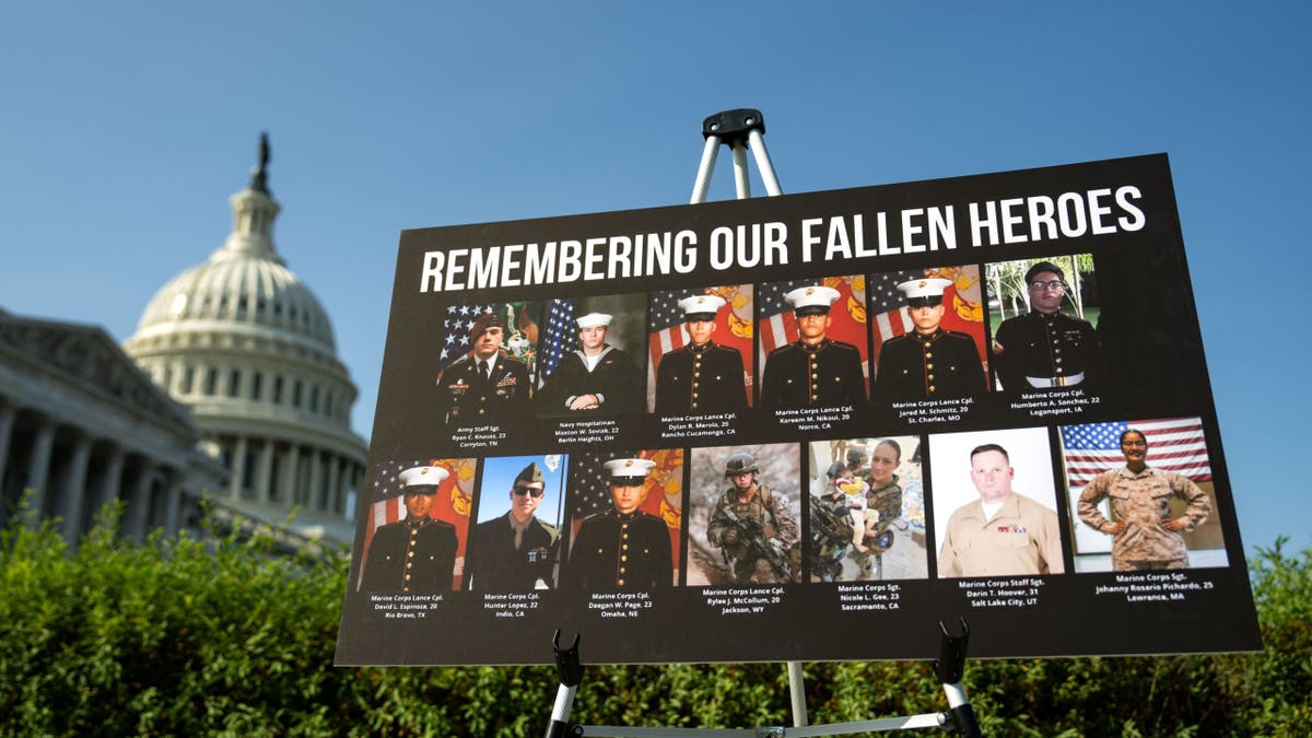 photo collage of 13 service members killed at Abbey Gate, Kabul, on display on Capitol HIll