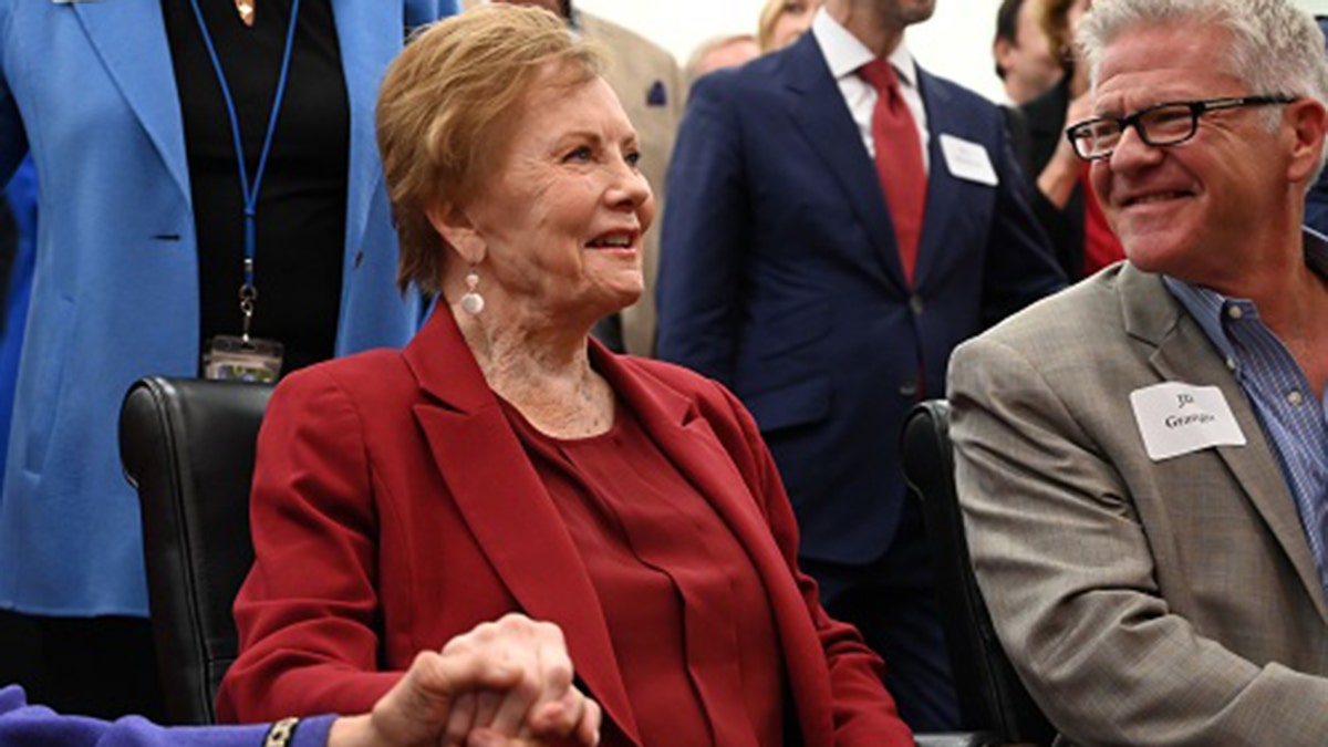 Kay Granger, R-Texas, in red suit seated