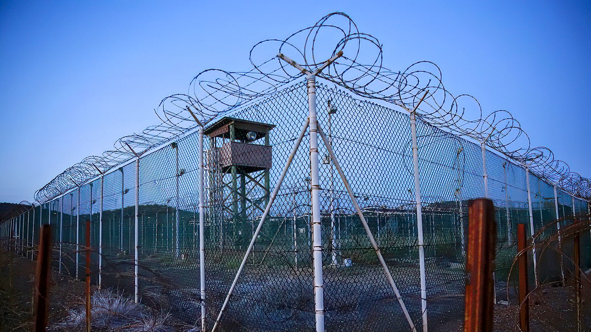 Chain link fence and concertina wire surrounds a deserted guard tower within Joint Task Force Guantánamo's Camp Delta at the U.S. Naval Base in Guantánamo Bay, Cuba, in March 2016.