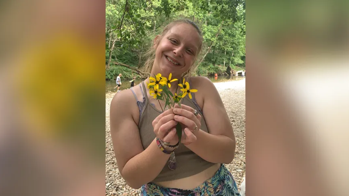 Aspen Lewis holding yellow flowers