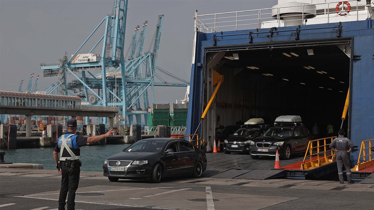 Cars drive off of a barge onto a port in Algeciras, Spain