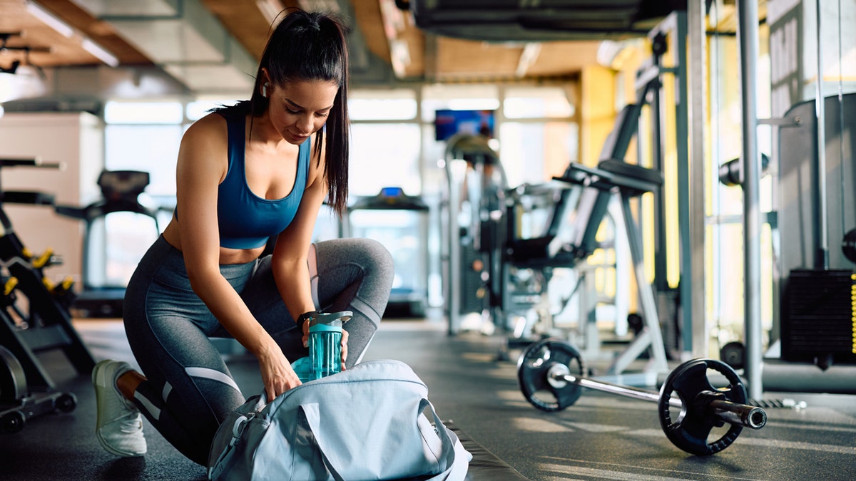 Woman with duffle bag at the gym