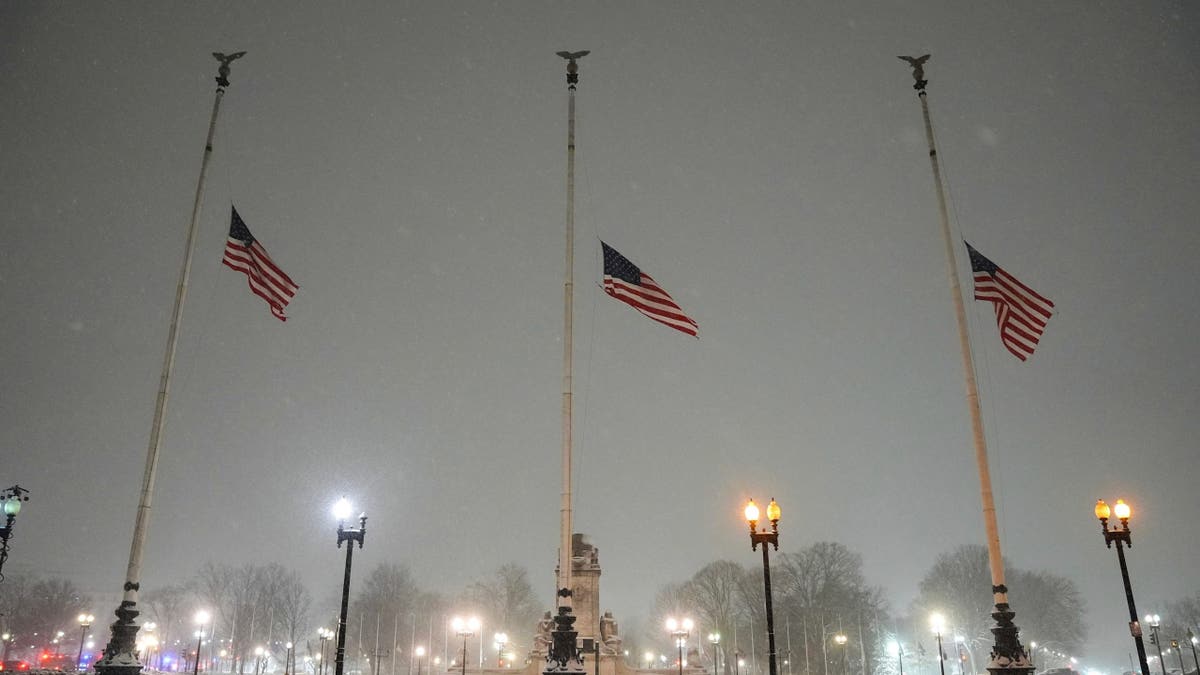 Flags fly at half-staff in memorial to former President Jimmy Carter during a winter snow storm at Union Station in Washington, D.C., on Monday, Jan. 6, 2025.