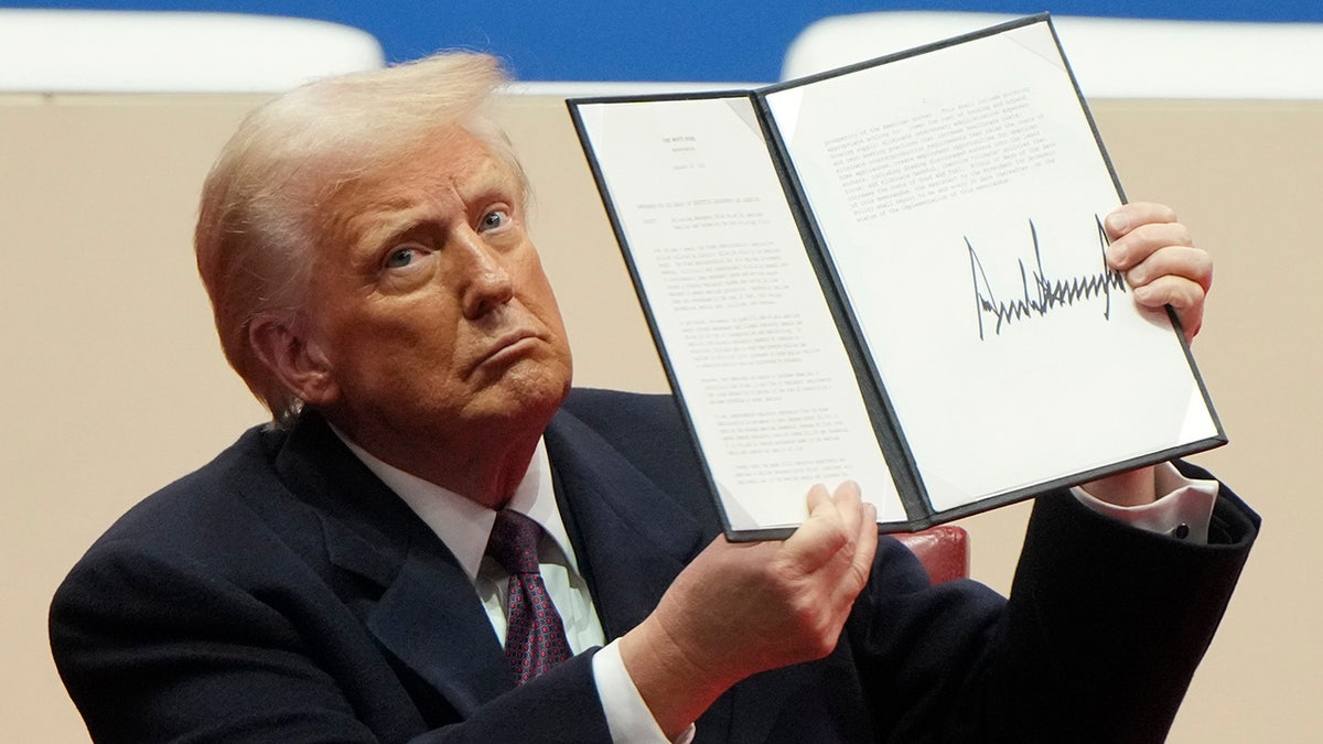 President Donald Trump closeup shot with signed pardon paper