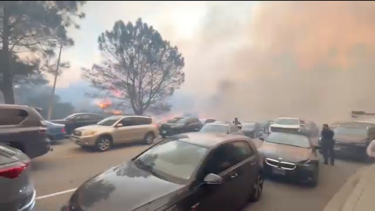 People evacuate cars during LA fires