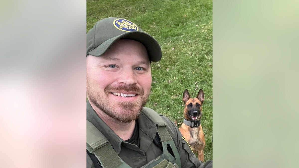 David 'Chris' Maland poses with a police dog