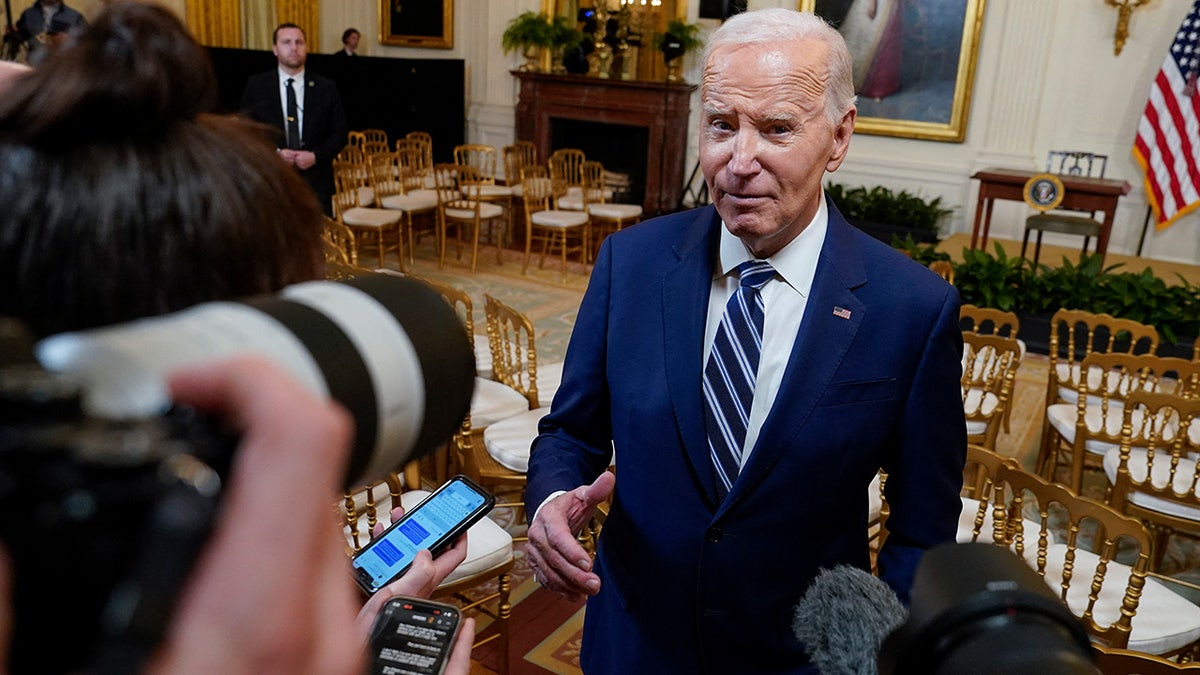 Biden surrounded by the press