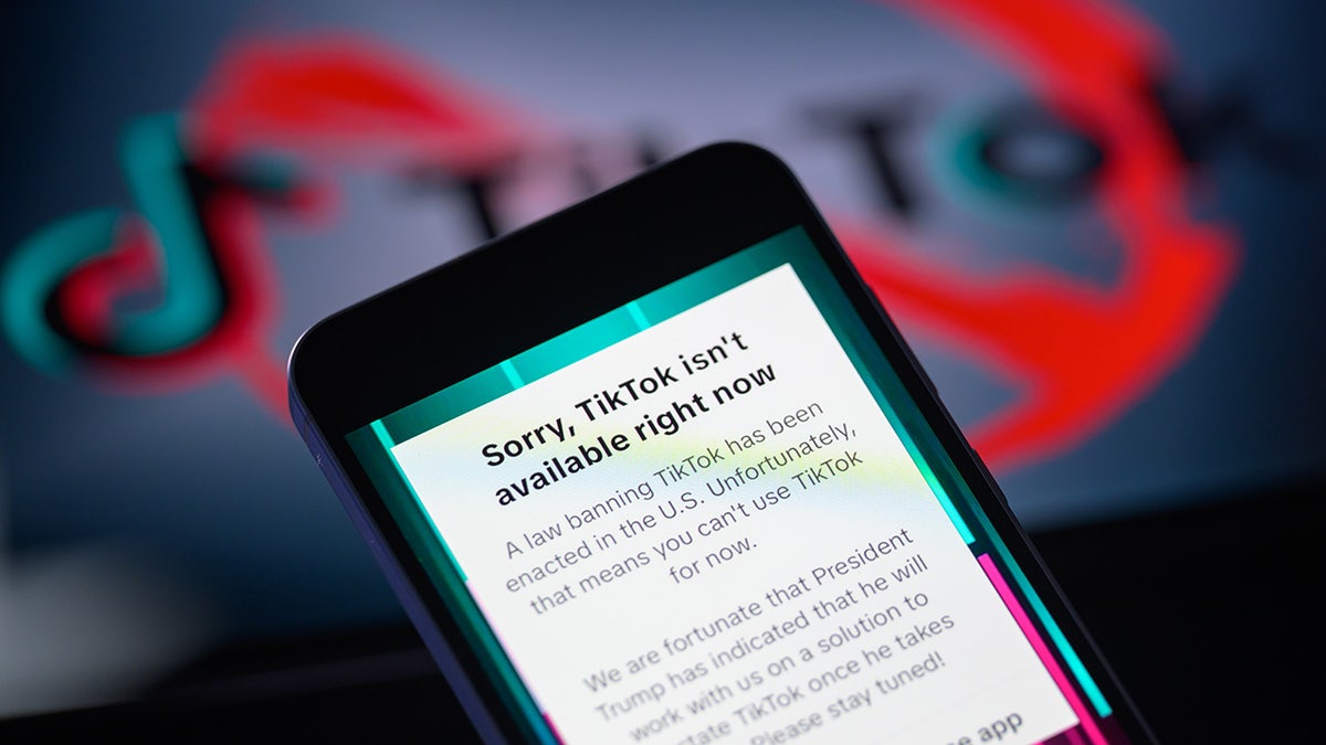 TikTok ban message appears on a mobile screen with TikTok logo on tablet screen