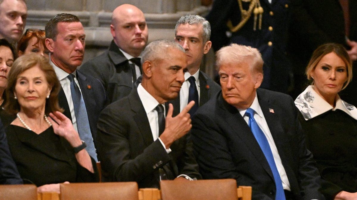 Former US President Barack Obama speaks with President-elect Donald Trump with Sean Curran in the background