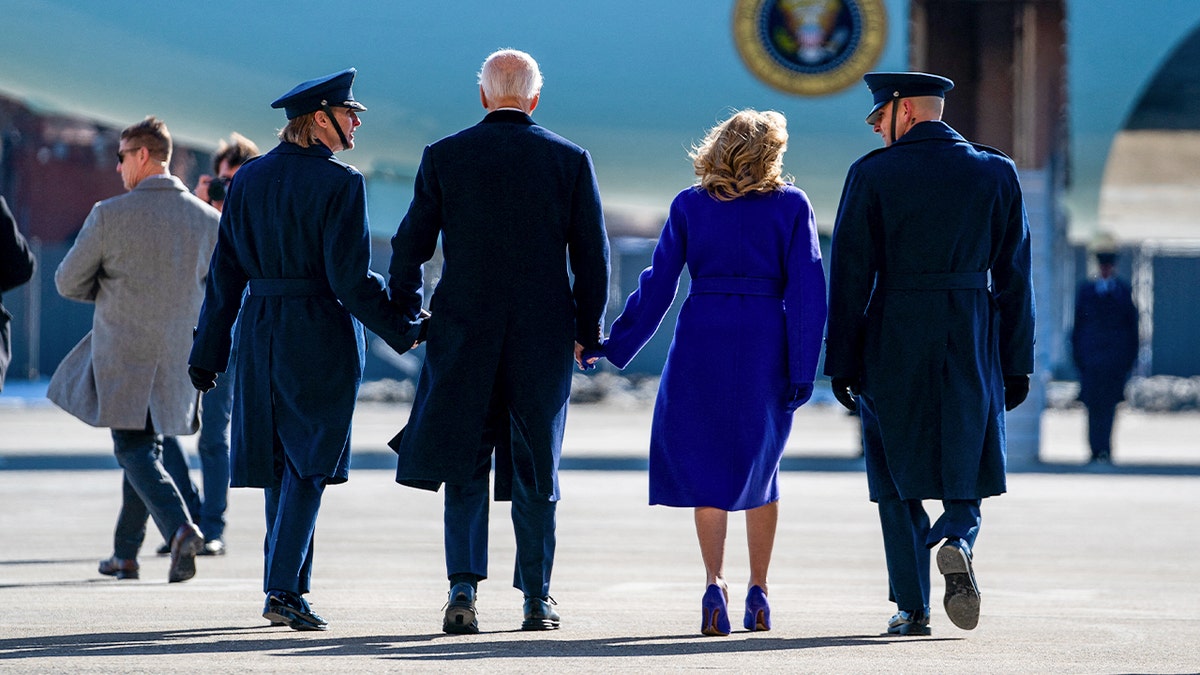 Former President Joe Biden and former First Lady Jill Biden walk towards Air Force One