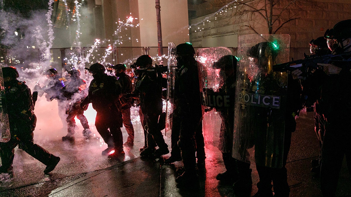 PORTLAND, OREGON, USA - DECEMBER 31: Protesters throw fireworks to police officers during a protest against police brutality near the Federal Courthouse in Portland, Oregon, United States on December 31, 2020. (Photo by John Rudoff/Anadolu Agency via Getty Images)