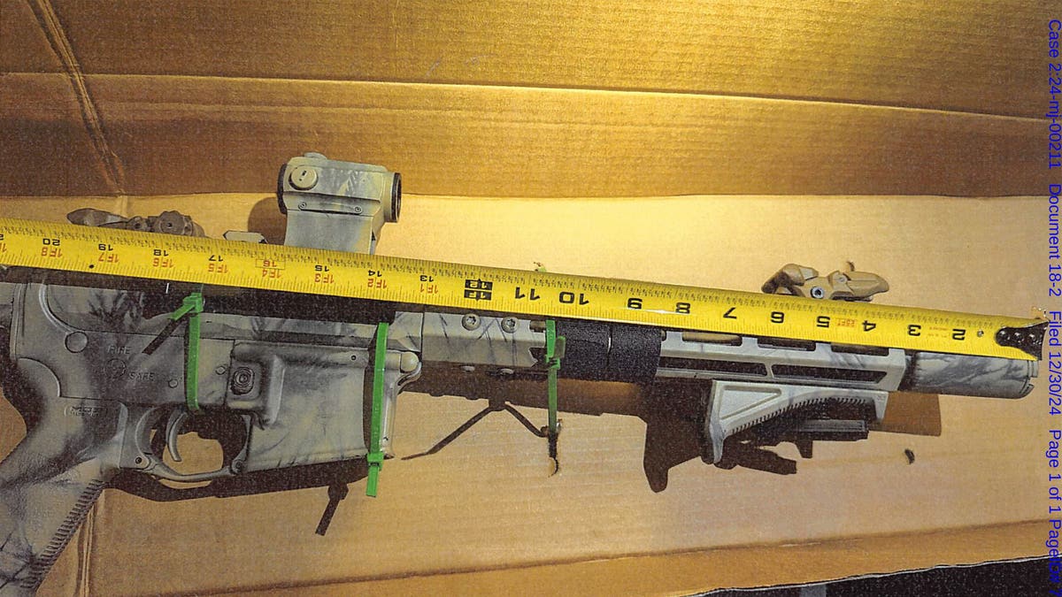 A rifle federal agents seized when they arrested Brad Spafford in Dec. 2024 is measured.