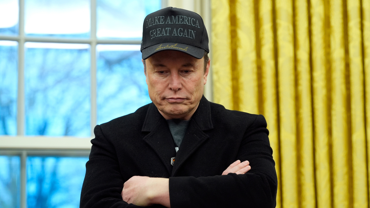 Elon Musk listens as President Donald Trump speaks with reporters in the Oval Office at the White House, on Tuesday, Feb. 11, 2025, in Washington. 