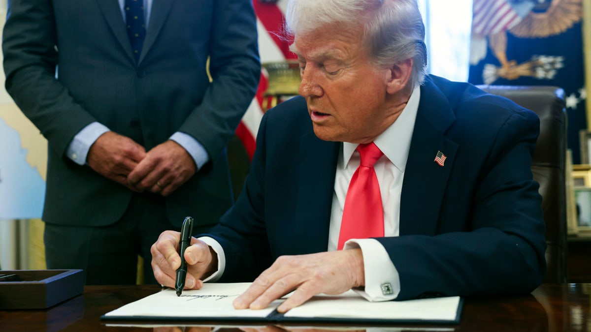 Donald Trump closeup shot signing executive order