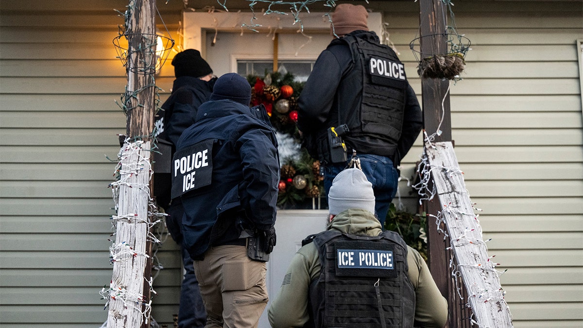 ICE agents outside a residence door