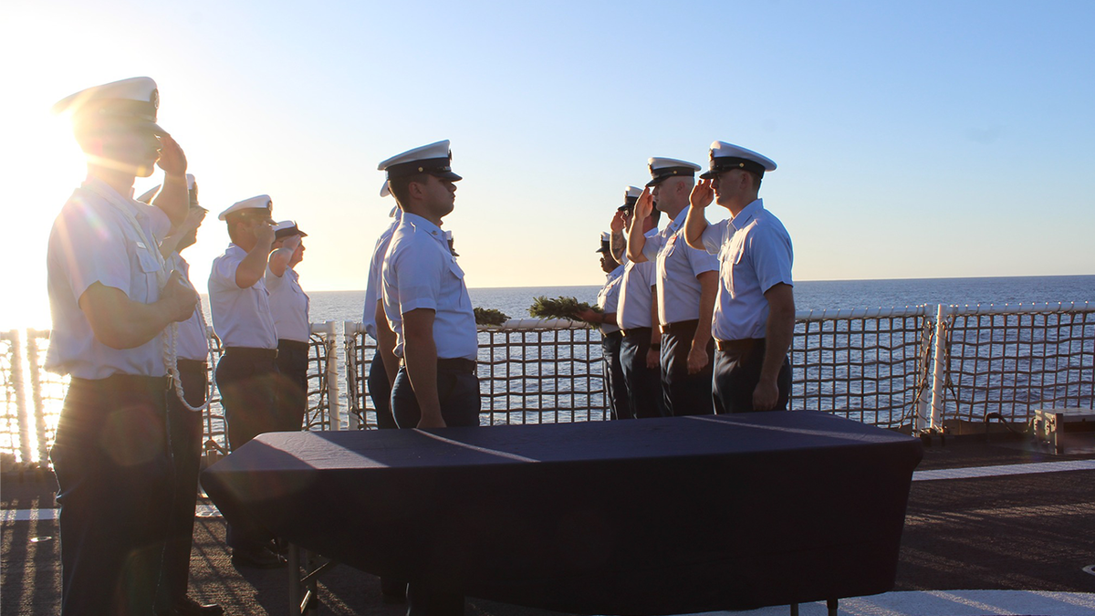 Crew members assigned to U.S. Coast Guard Cutter Waesche (WMSL 751) in the memorial cordon salute their fallen shipmate, Petty Officer 3rd Class Travis 'Obie' Obendorf, a Boatswain’s Mate who served on Waesche in 2013. BM3 Obendorf’s memorial ceremony set aside time for the crew to remember and celebrate the beloved crew member who sacrificed his life serving others.