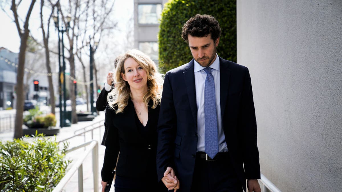 Former Theranos CEO Elizabeth Holmes alongside her boyfriend Billy Evans