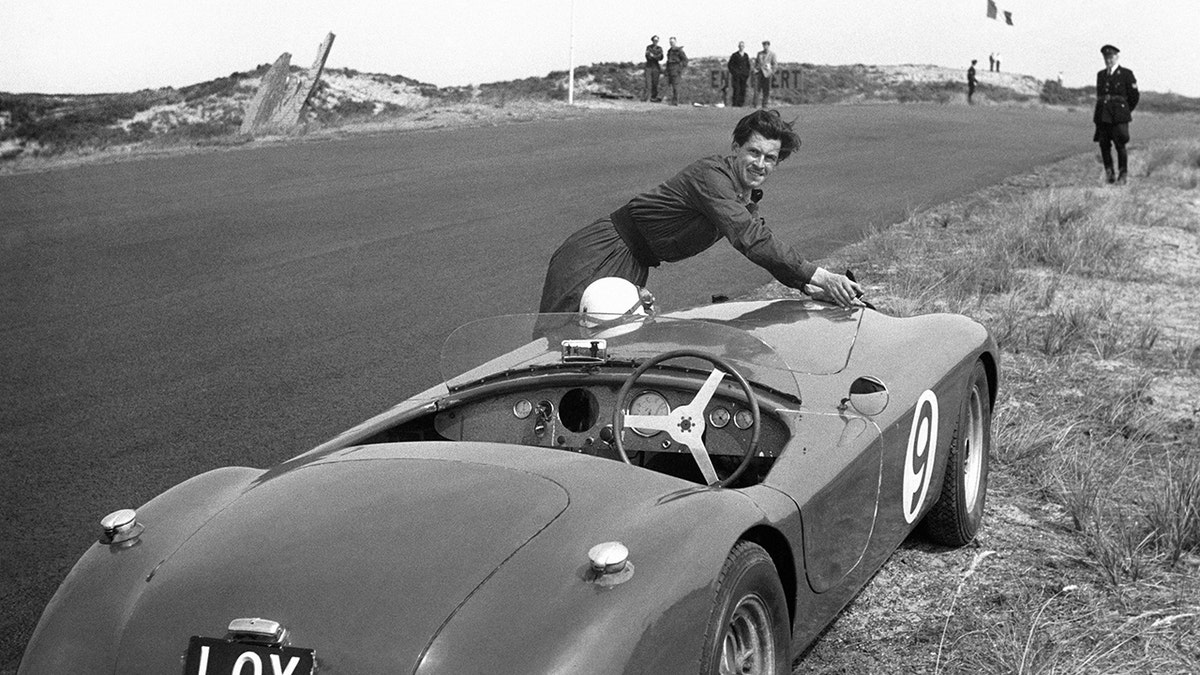 David Blakely cleaning his car outdoors.