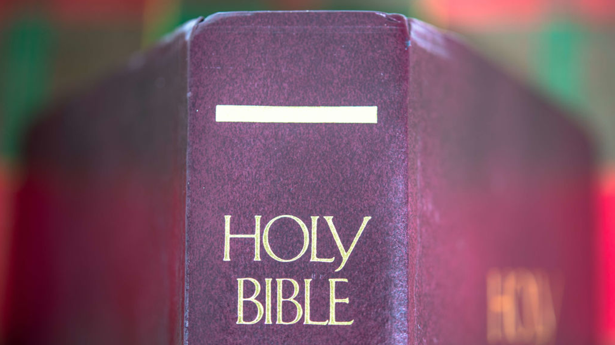 A picture of the Bible bound in a reddish leather