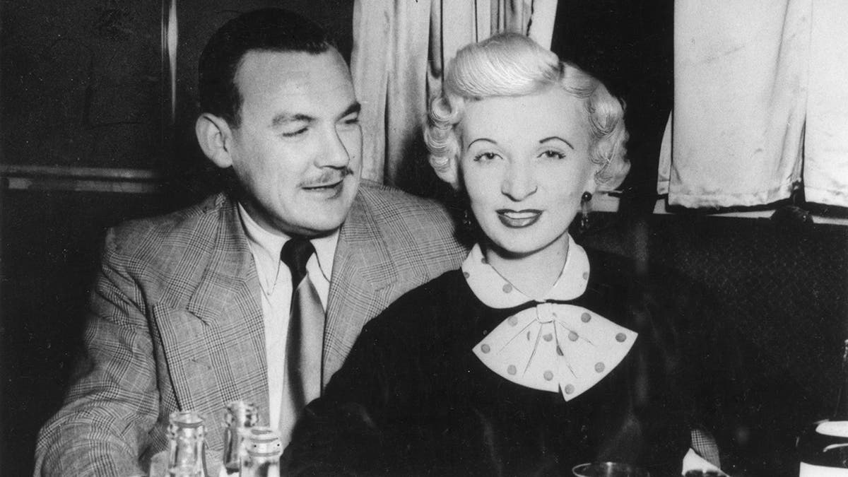 Desmond looking at Ruth Ellis as they sit together.