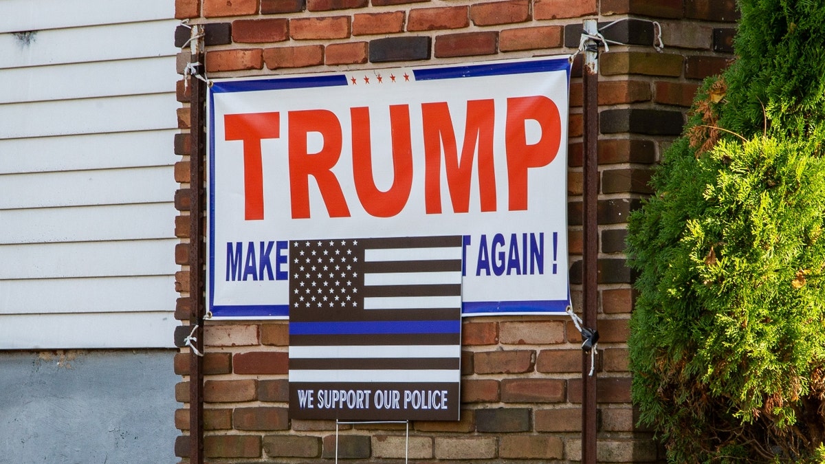 A blue lives matter sign and a Trump sign are displayed on a house in central Pennsylvania.