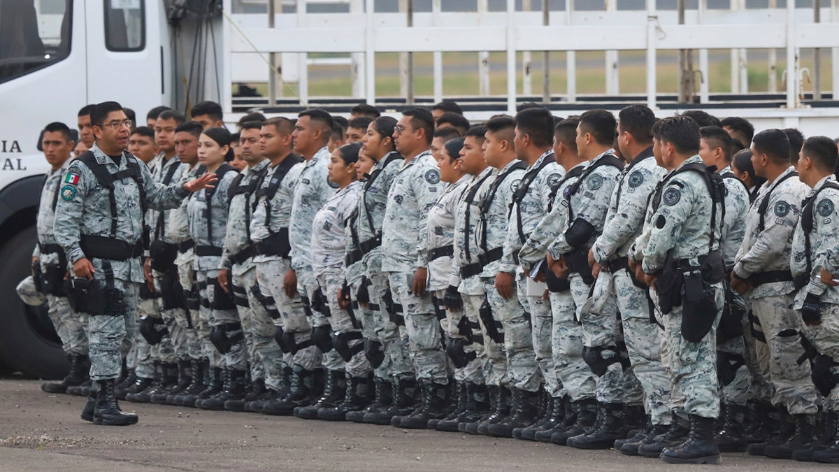 Mexican National Guard members line up at plane