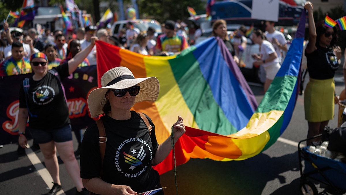 military personnel in street clothes in LGBT pride parade