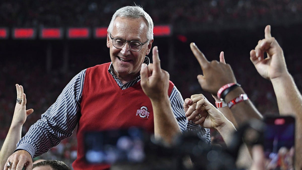 Former Ohio State coach Jim Tressel is carried on the shoulders of his 2002 national championship team during the second quarter of an NCAA college football game between Notre Dame and Ohio State, Saturday, Sept. 3, 2022, in Columbus, Ohio. 