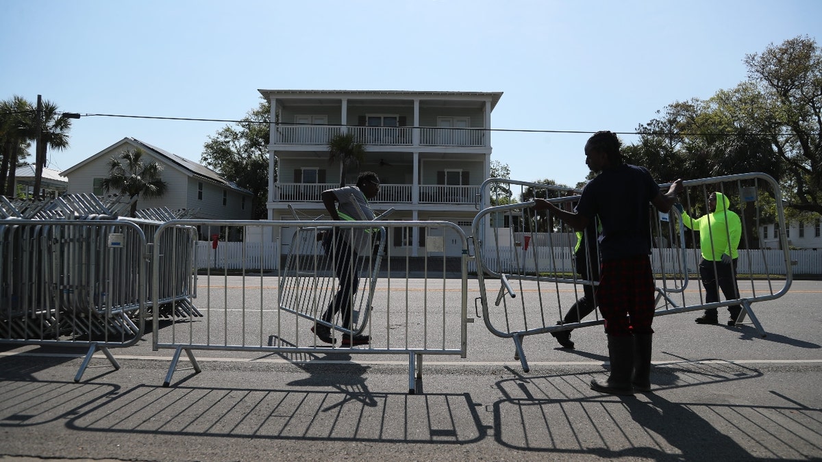 Workers use steel barricades to block on street parking and side streets along Butler Avenue on Tuesday, April 16, 2024 as the City of Tybee Island prepares for Orange Crush, which is an unpermitted event expected to take place the 19-21.