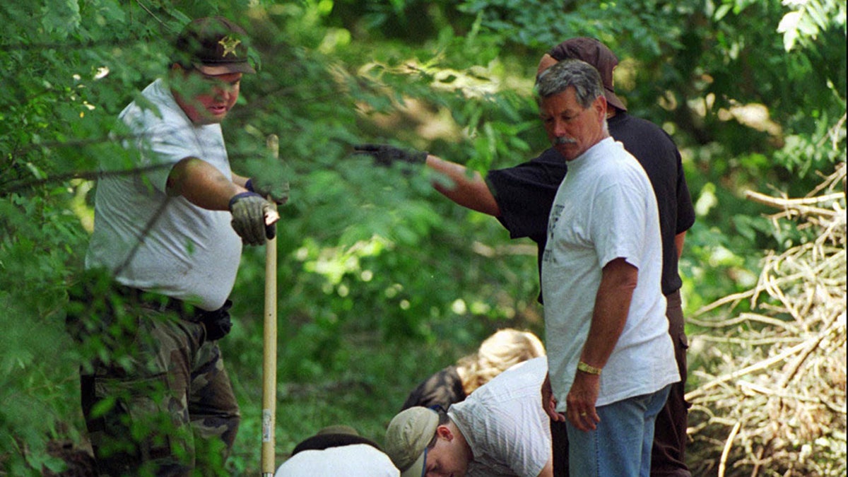 Investigators searching on the Fox Hollow Farm grounds.